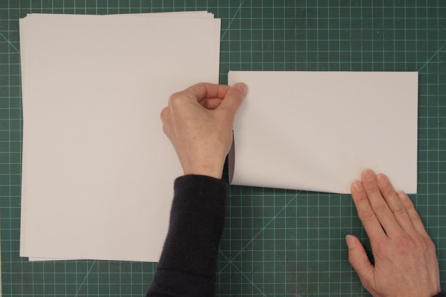 Folding blank sheets of paper in half