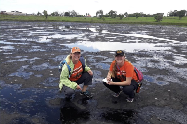 Two students on \site at a tar pit in Trinidad