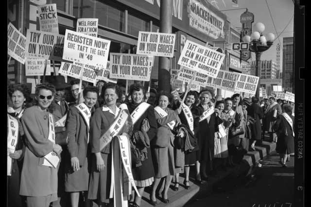 black and white photo of women holding signs