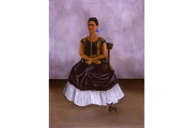 Frida Kahlo self portrait with small dog at forefront