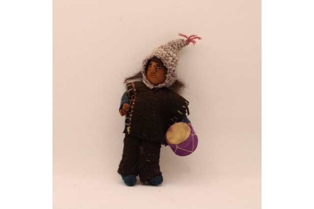 a doll of a Peruvian man with a drum and knit cap