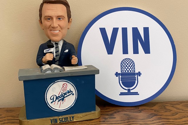 bobblehead of Vin Scully at desk