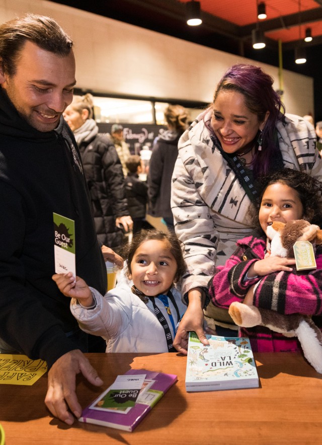 Family enjoying raffle prizes at a party at night