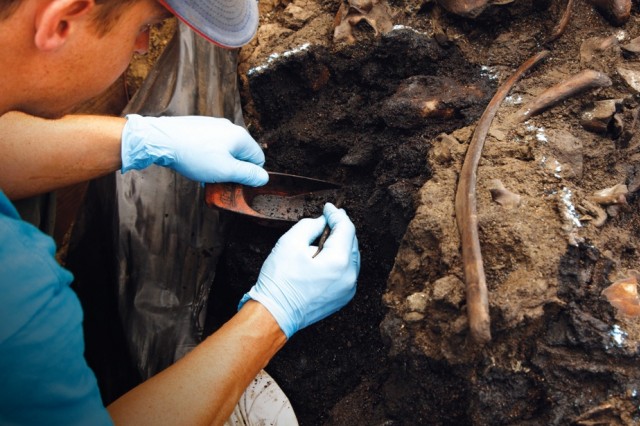 Photo of paleontologist excavating fossils 