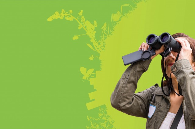 Woman using binoculars to observe nature