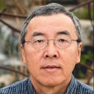 Scientist with glasses looks straight ahead